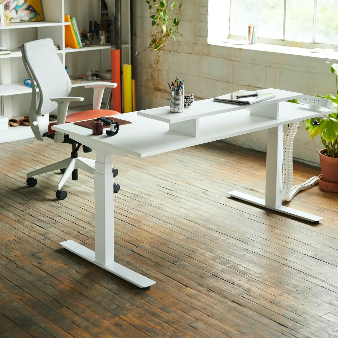 A bright office desk by a large window at Acharya Technologies